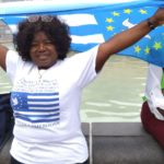 Comrade Electta Shalo holding high the Southern Cameroons flag